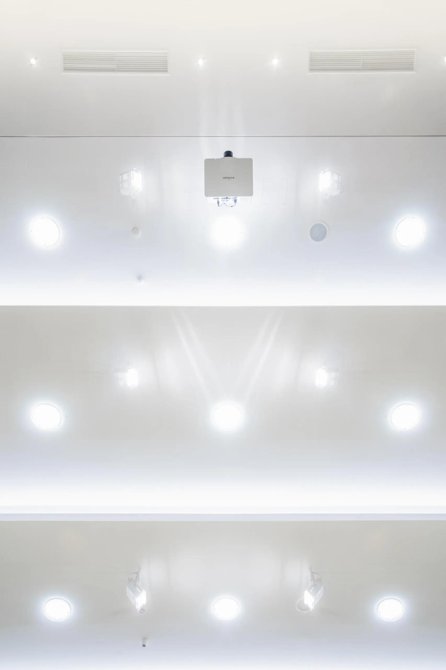 Modern ceiling with recessed lighting and projector. Interior architecture photography.